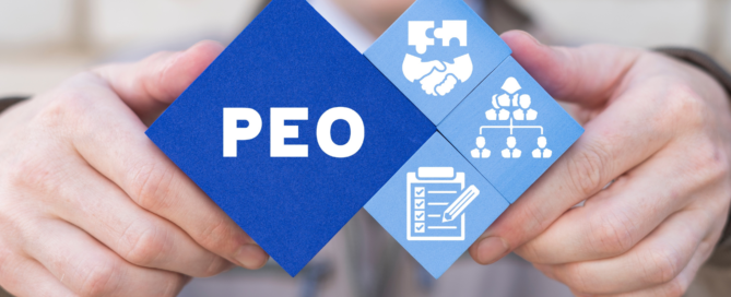 man holding up the letters PEO