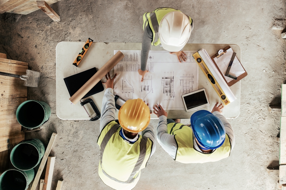 Top,View,,Construction,Workers,Or,Blueprint,Planning,In,House,,Home Employee Benefits Construction Industry