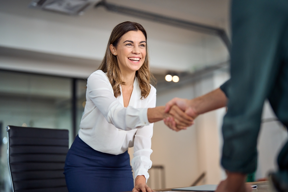 Happy,Mid,Aged,Business,Woman,Manager,Handshaking,Greeting,Client,In Employer Beneifts Broker Shopping