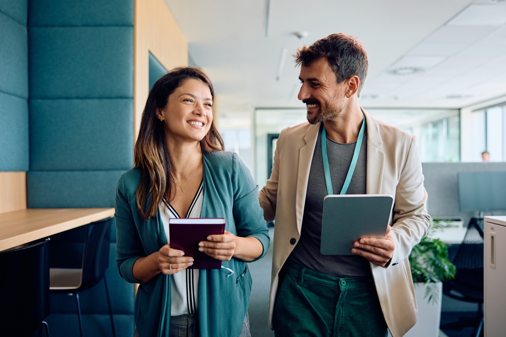 Happy,Businessman,Communicating,With,Female,Colleague,While,Walking,Through,The Spousal Audits and Surcharges
